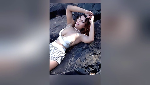 Red-haired amateur teen in a bikini is on the beach and doing solo sex