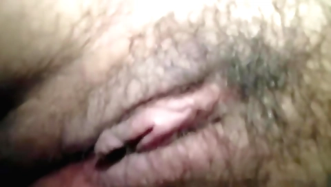 Hairy solo female masturbates with a vibrator and masturbates