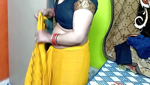 Indian solo female wearing yellow sari and showing off